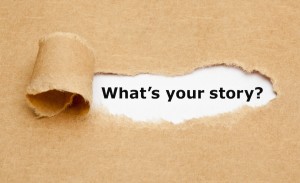 The text What's Your Story appearing behind torn brown paper.